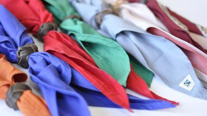Halstücher der Stufenfarben (orange, blau, rot, grün, grau und weiß) liegen nebeneinander